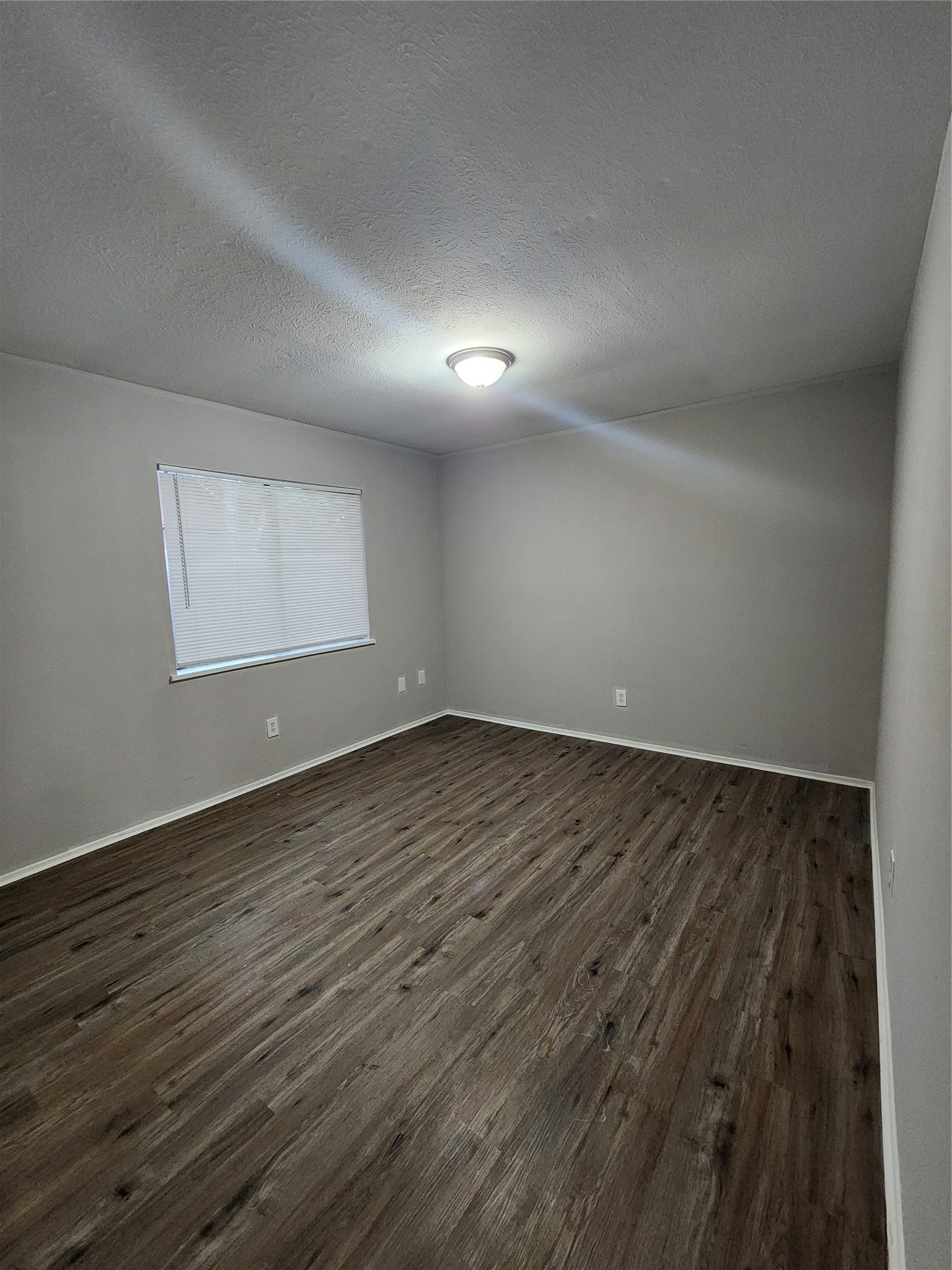 3822 Broken Elm Drive Spring, TX 77388 - Photo 22 of 25 an empty room with wooden floor and windows