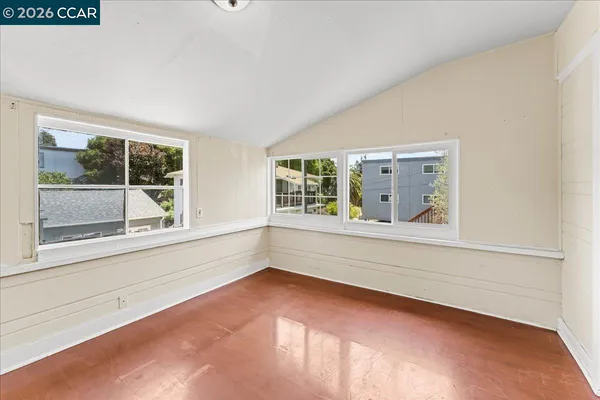 a view of a room with wooden floor and white wall