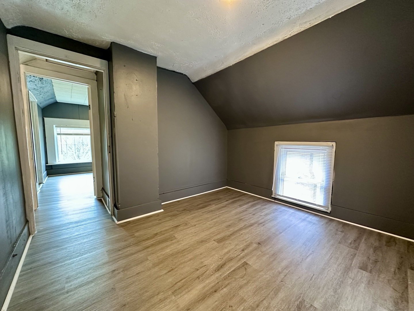 704 West 7th Street Sterling, IL 61081 - Photo 12 of 16 an empty room with wooden floor and windows