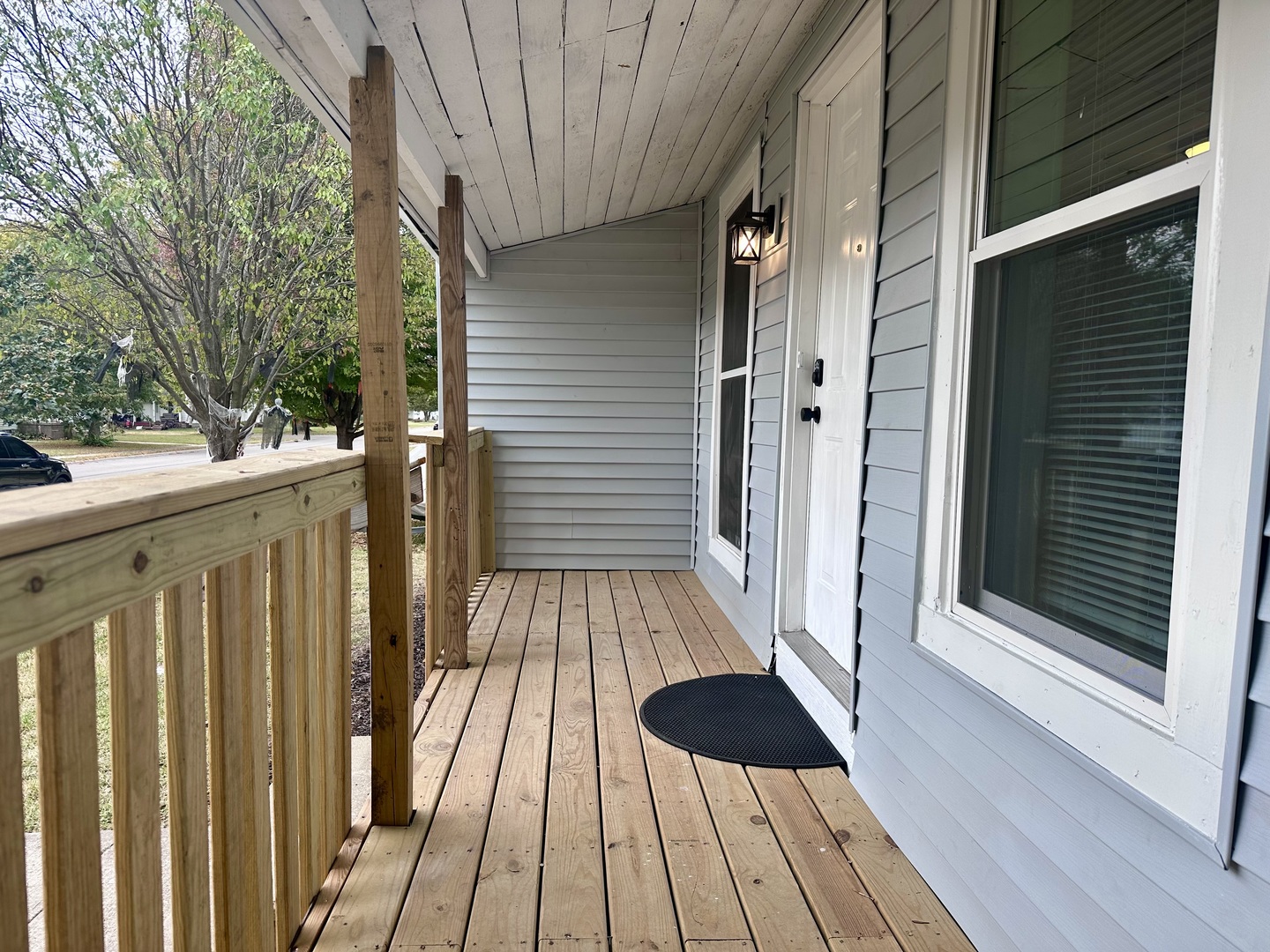 704 West 7th Street Sterling, IL 61081 - Photo 2 of 16 a view of a balcony with wooden floor and fence
