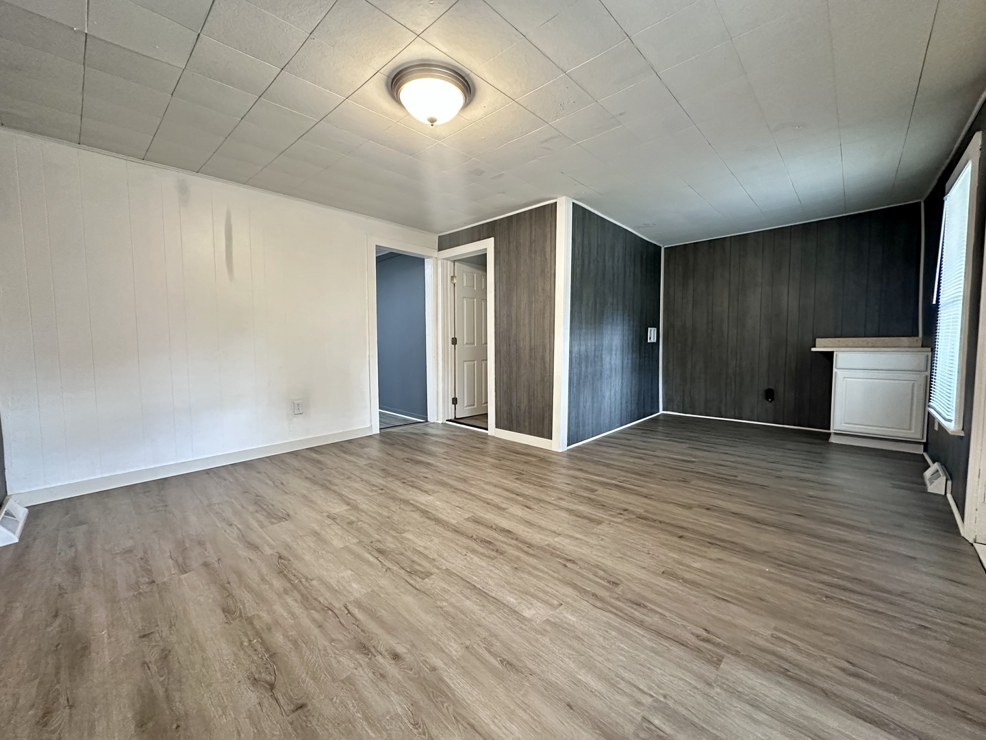 704 West 7th Street Sterling, IL 61081 - Photo 3 of 16 an empty room with wooden floor and toilet