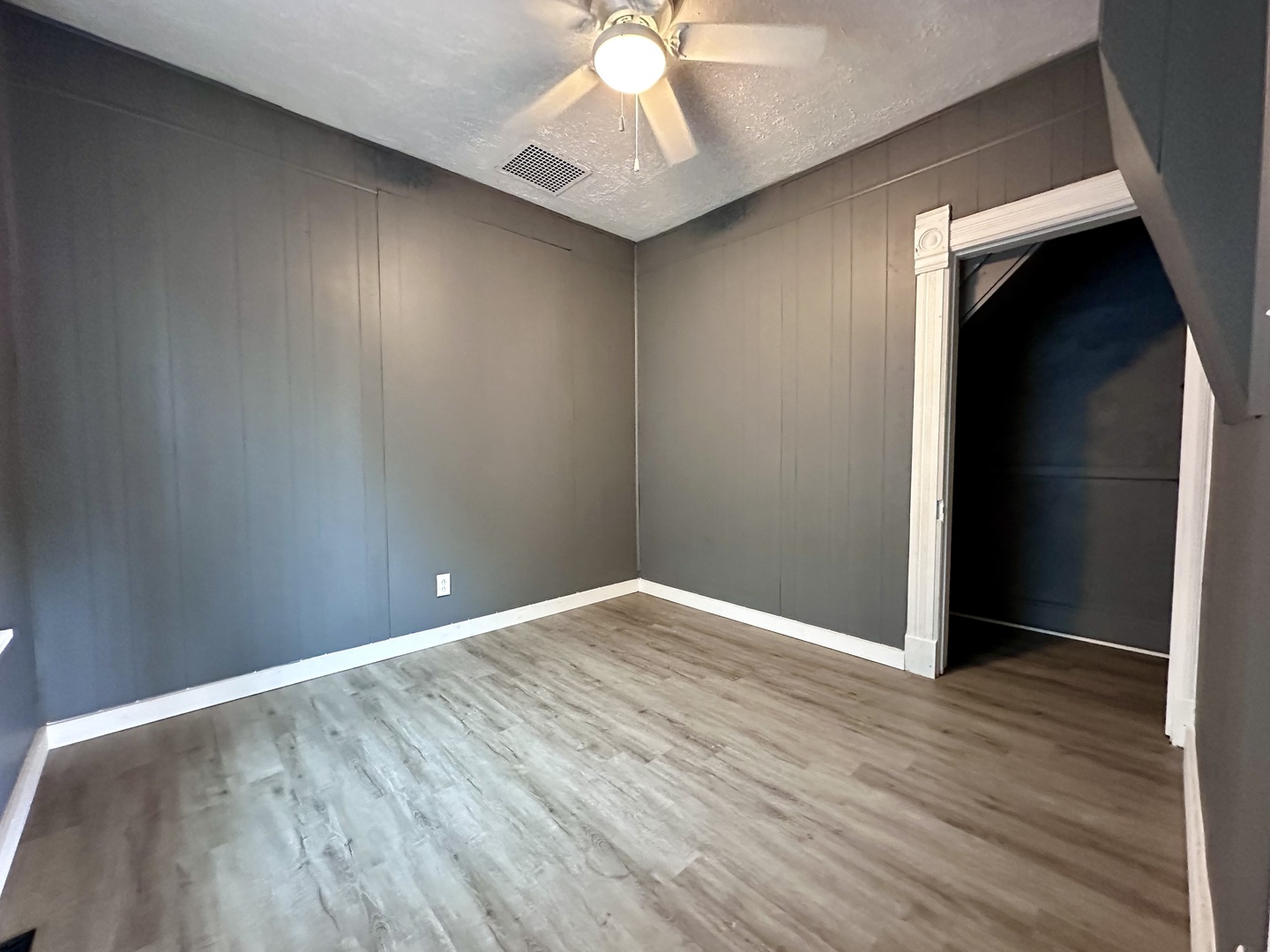 704 West 7th Street Sterling, IL 61081 - Photo 5 of 16 wooden floor in an empty room with a window