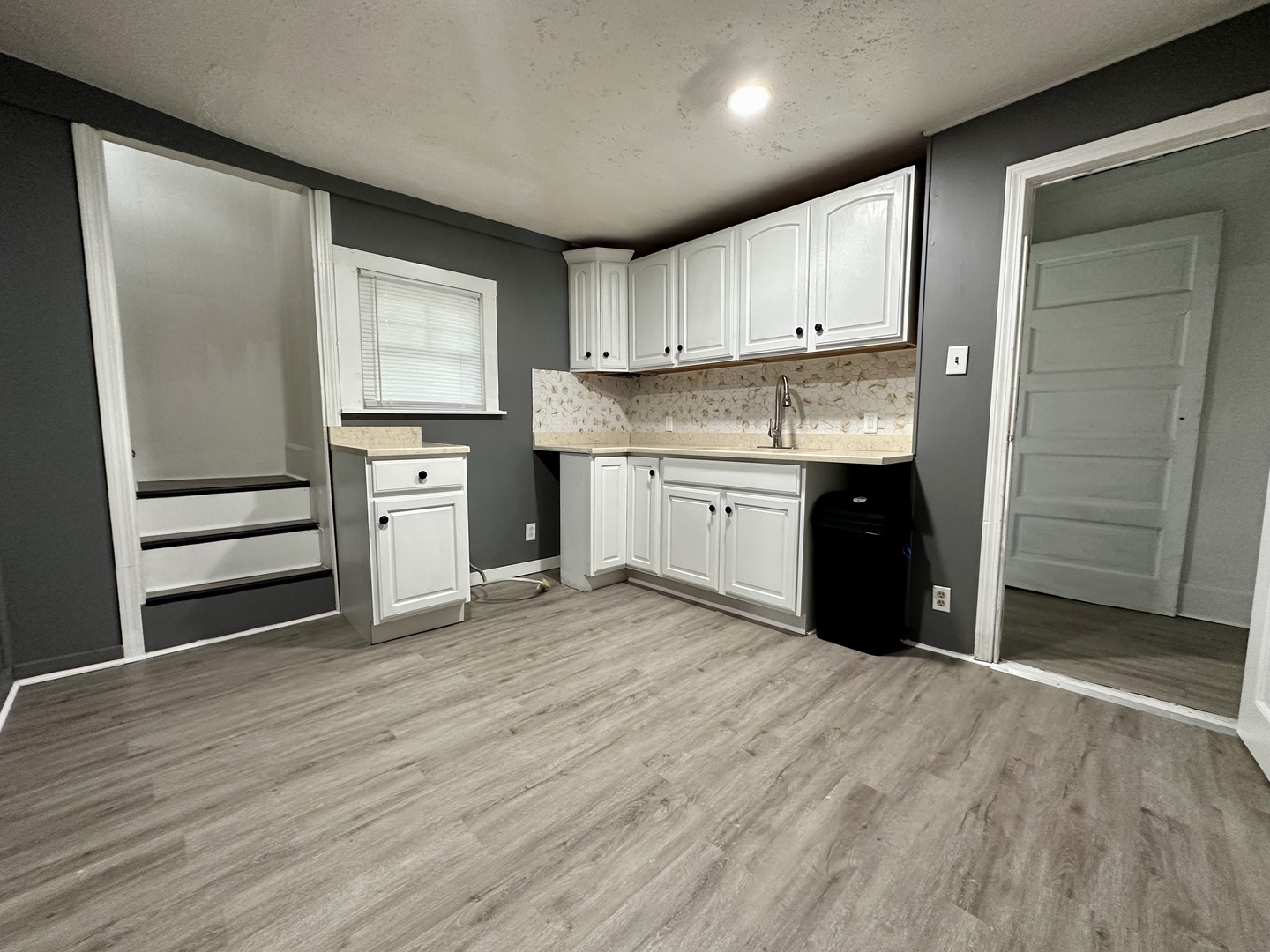 704 West 7th Street Sterling, IL 61081 - Photo 8 of 16 a large kitchen with granite countertop a stove and a sink
