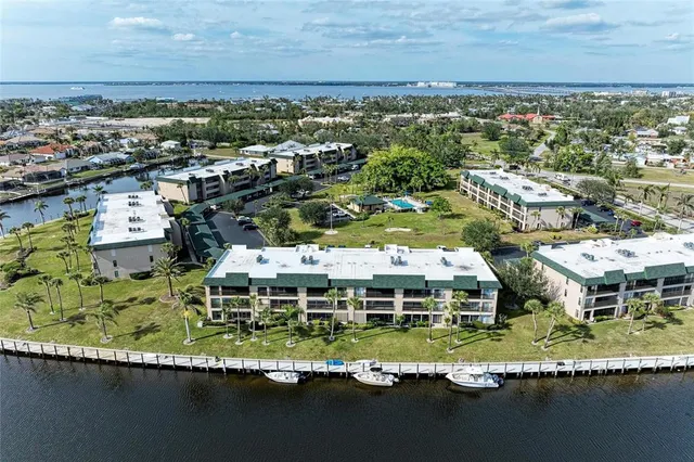 an aerial view of residential houses with outdoor space and swimming pool