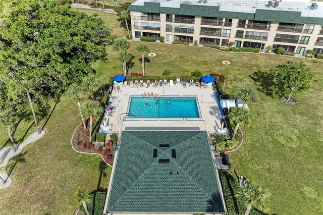 an aerial view of residential houses with outdoor space and ocean view