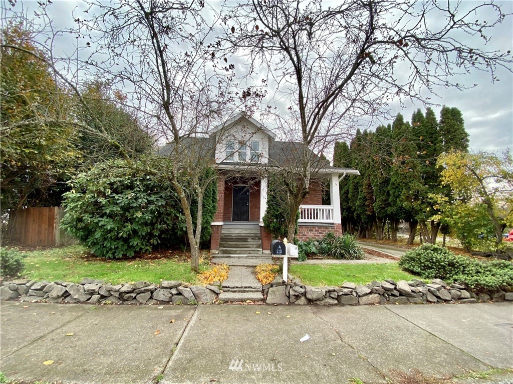 215 South Tobin Street Renton, WA 98057 - Photo 1 of 1 a front view of a house with garden and trees