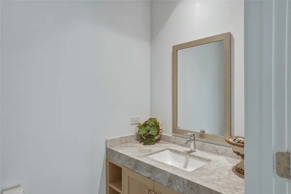 a living room with furniture a flat screen tv and floor to ceiling window