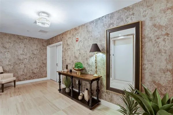 a living room with furniture a flat screen tv and a large window