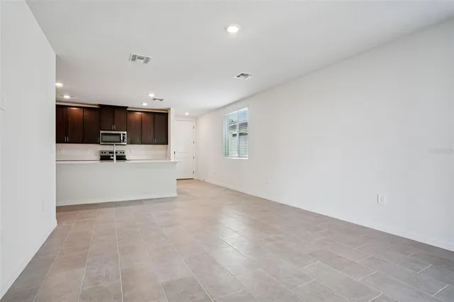 a view of a kitchen with microwave and cabinets