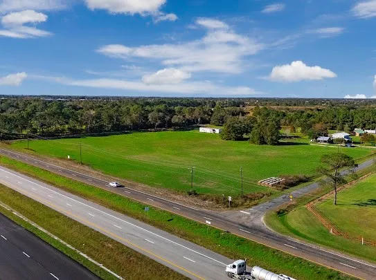 a view of a golf course with car parked