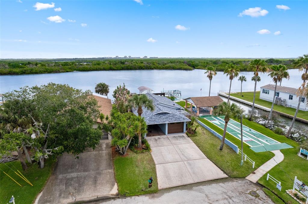29 Pelican Lane Edgewater, FL 32141 - Photo 30 of 39 a view of a lake with houses in background