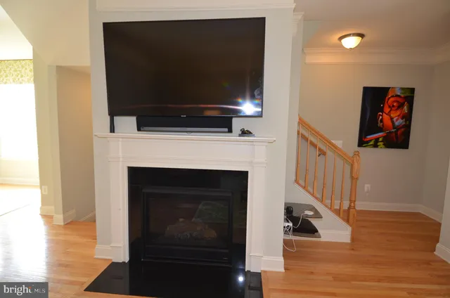 a living room with a fireplace and a flat screen tv