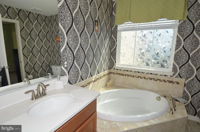 a bathroom with a bathtub and a sink
