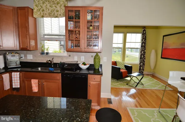 a kitchen with granite countertop sink and cabinets