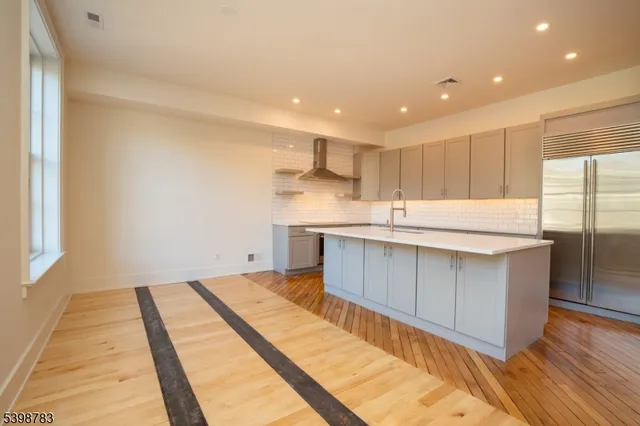 a kitchen with granite countertop a sink and cabinets
