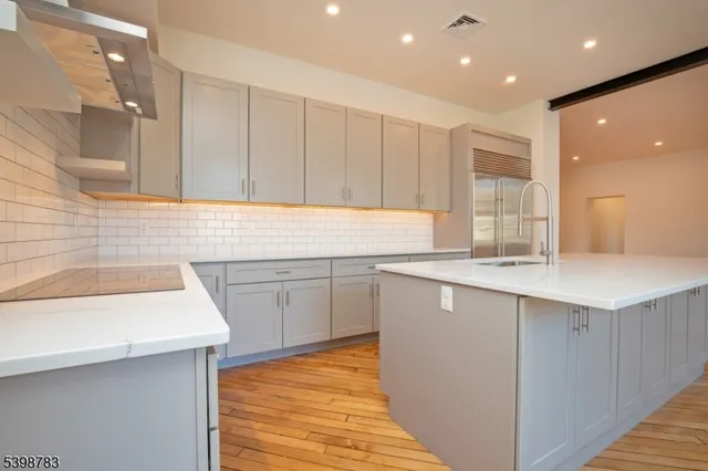 a kitchen with a sink window and cabinets
