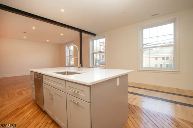 a bathroom with a sink a vanity and a large mirror