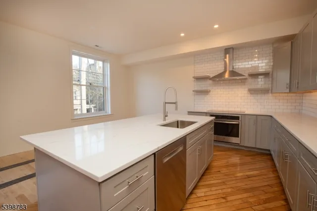 a kitchen with a stove a sink and a refrigerator