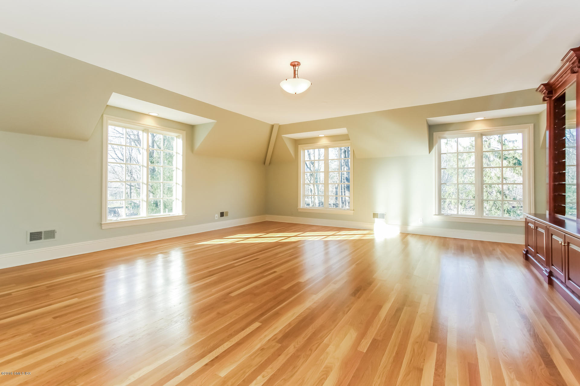 591 Round Hill Road Greenwich, CT 06831 - Photo 21 of 51 a view of an empty room with wooden floor and a window