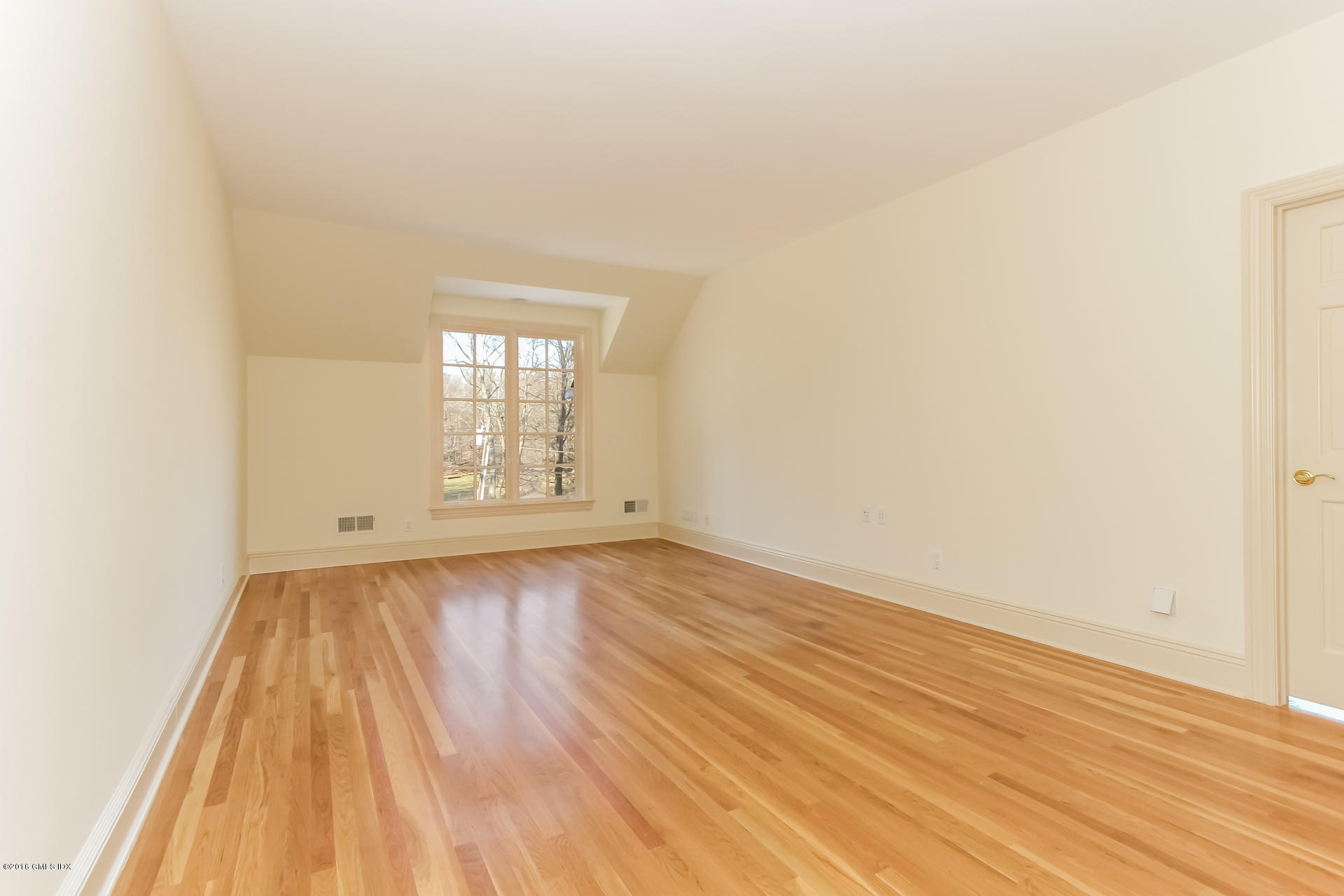 591 Round Hill Road Greenwich, CT 06831 - Photo 31 of 51 an empty room with wooden floor and windows