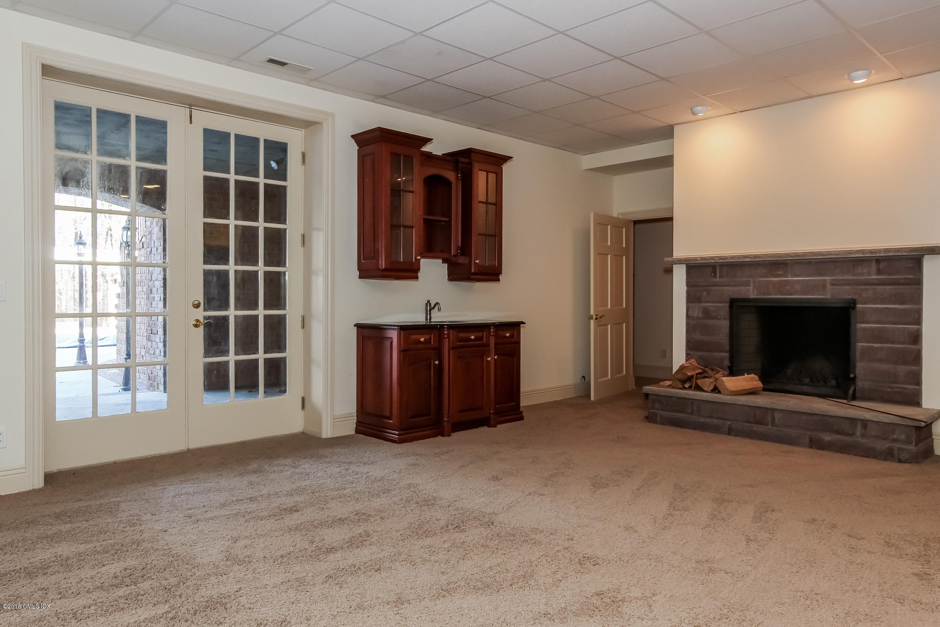 591 Round Hill Road Greenwich, CT 06831 - Photo 36 of 51 a view of an empty room with a fireplace and a window