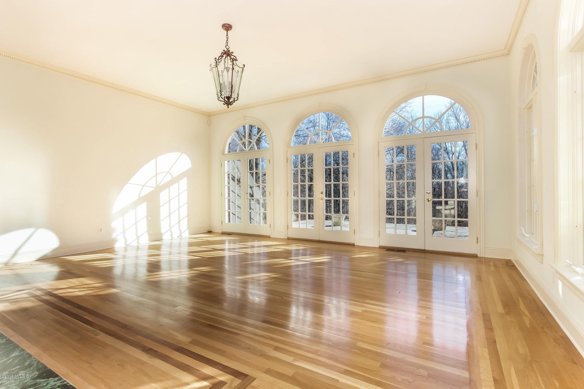591 Round Hill Road Greenwich, CT 06831 - Photo 6 of 51 a view of empty room with wooden floor and fan