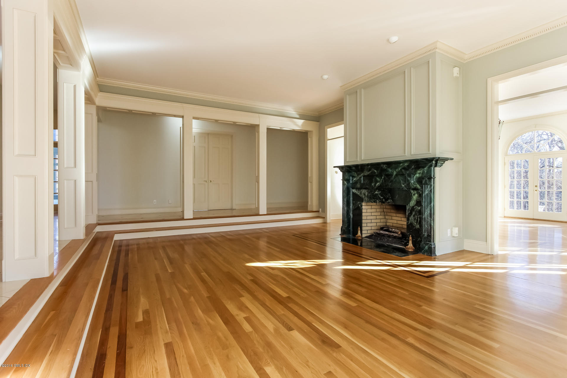 591 Round Hill Road Greenwich, CT 06831 - Photo 8 of 51 a view of empty room with wooden floor and fireplace