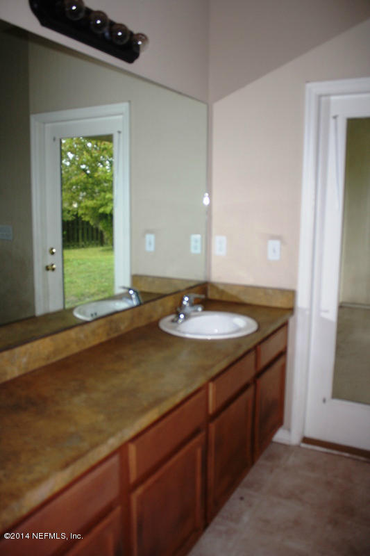 14631 Millhopper Road Jacksonville, FL 32258 - Photo 14 of 21 a bathroom with a sink and a window