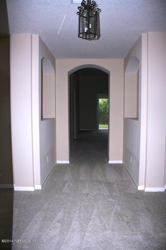14631 Millhopper Road Jacksonville, FL 32258 - Photo 2 of 21 a view of a hallway with wooden shelves
