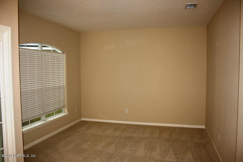 14631 Millhopper Road Jacksonville, FL 32258 - Photo 3 of 21 a view of an empty room with a window