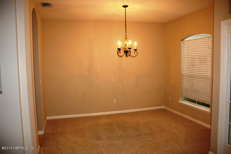 14631 Millhopper Road Jacksonville, FL 32258 - Photo 4 of 21 a view of empty room with windows and chandelier