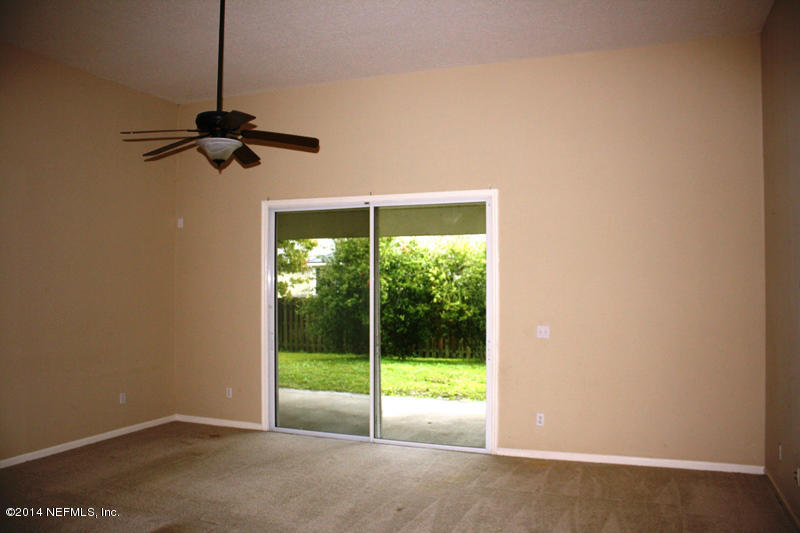 14631 Millhopper Road Jacksonville, FL 32258 - Photo 5 of 21 a view of an empty room with a window