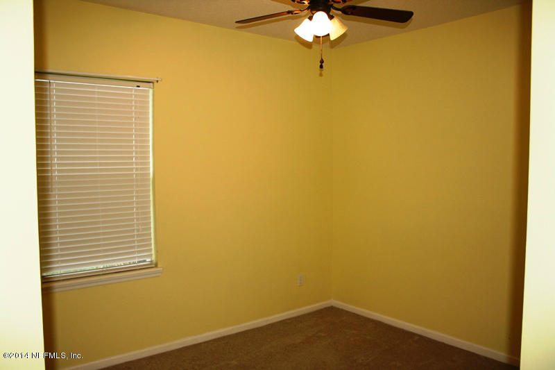 14631 Millhopper Road Jacksonville, FL 32258 - Photo 10 of 21 a view of a small space with wooden floor and a window