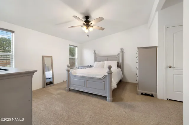 a bed room with a bed and a chandelier