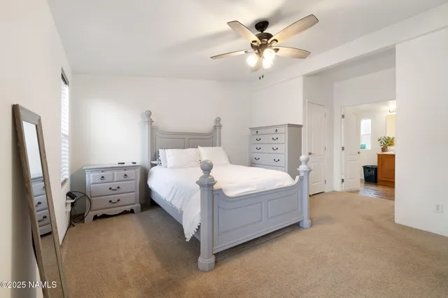 a spacious bathroom with a double vanity sink a mirror and shower