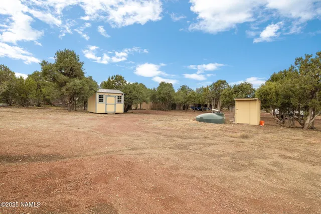 a view of dirt field with mountain in the background
