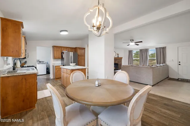 a view of a dining room with furniture large window and wooden floor