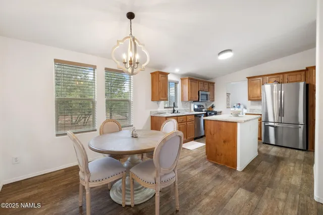 a kitchen with granite countertop a sink a counter space appliances and cabinets