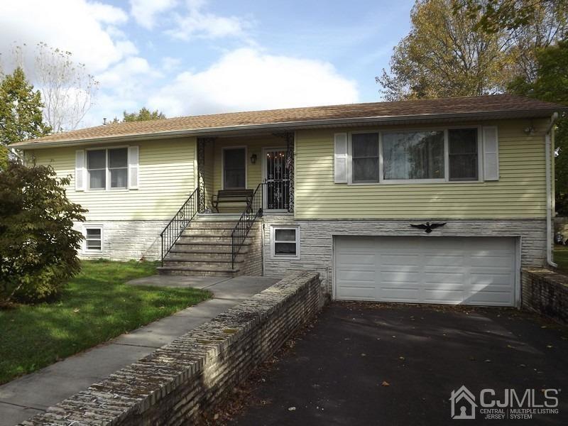 3 Butcher Road Monroe Township, NJ 08831 - Photo 1 of 11 a front view of a house with garden