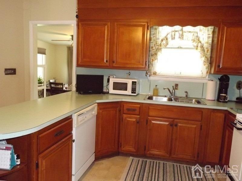 3 Butcher Road Monroe Township, NJ 08831 - Photo 3 of 11 a kitchen with stainless steel appliances a sink stove and cabinets