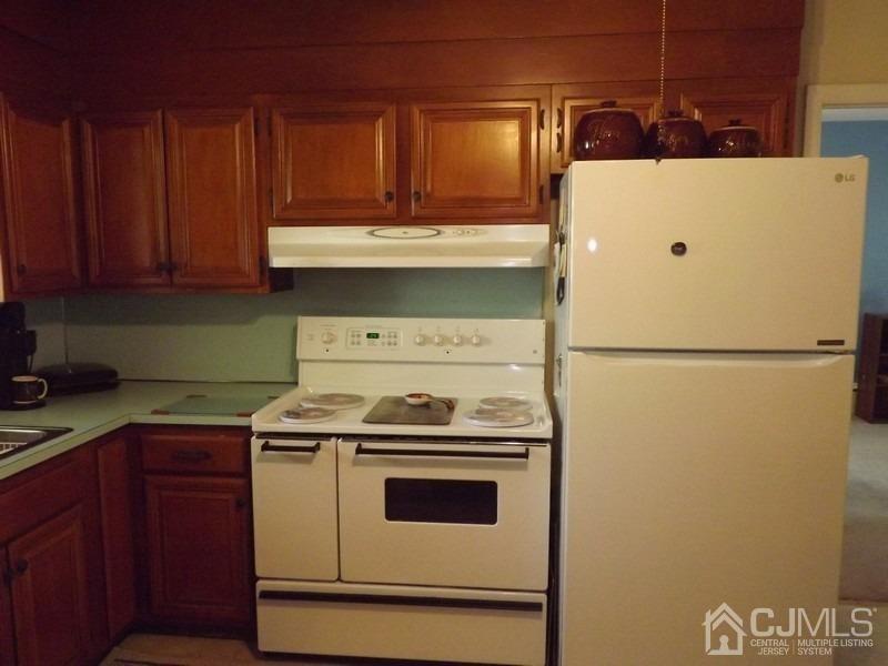 3 Butcher Road Monroe Township, NJ 08831 - Photo 4 of 11 a kitchen with a stove and a refrigerator