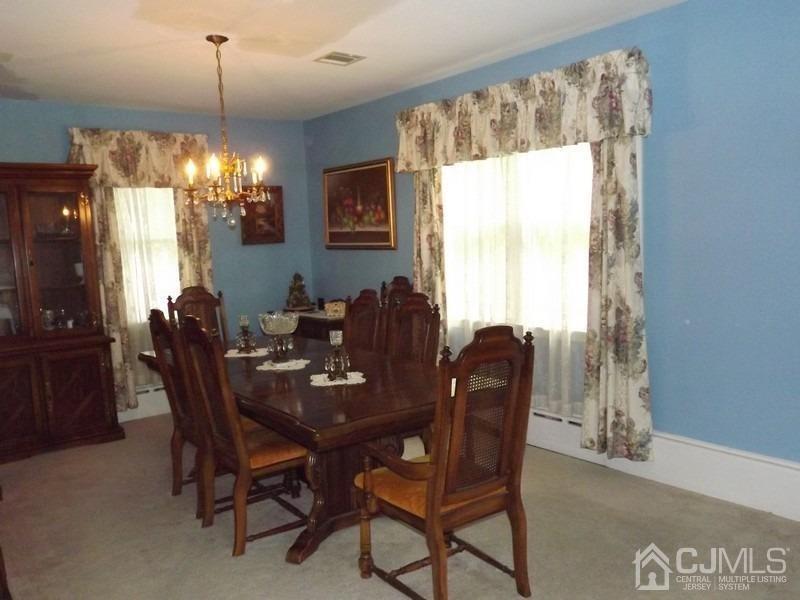3 Butcher Road Monroe Township, NJ 08831 - Photo 6 of 11 a dining room with furniture a chandelier and window