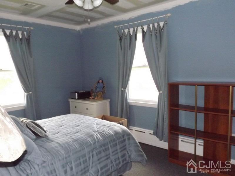 3 Butcher Road Monroe Township, NJ 08831 - Photo 7 of 11 a bedroom with a bed and a window