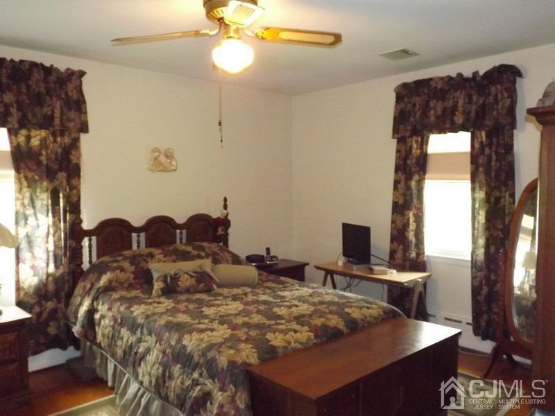 3 Butcher Road Monroe Township, NJ 08831 - Photo 8 of 11 a bed sitting in a bedroom next to a window