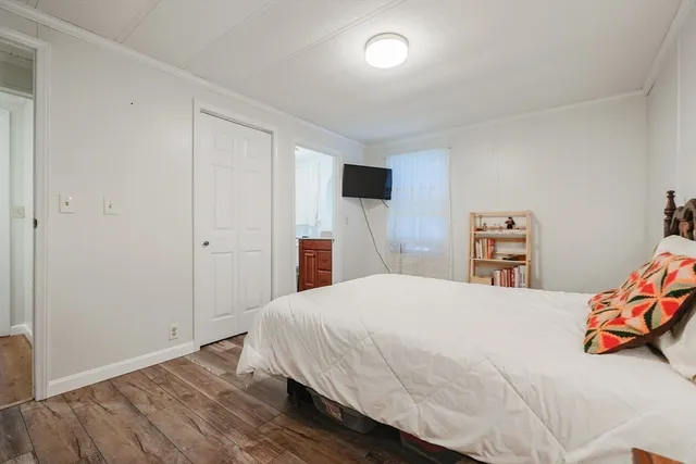 a bedroom with a bed and a tv