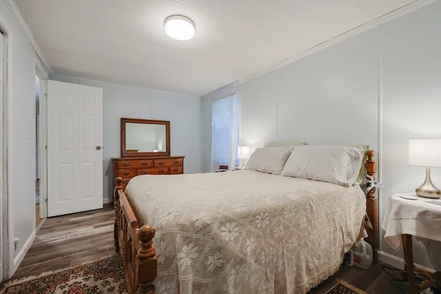 a bed sitting in a bedroom and a night stand