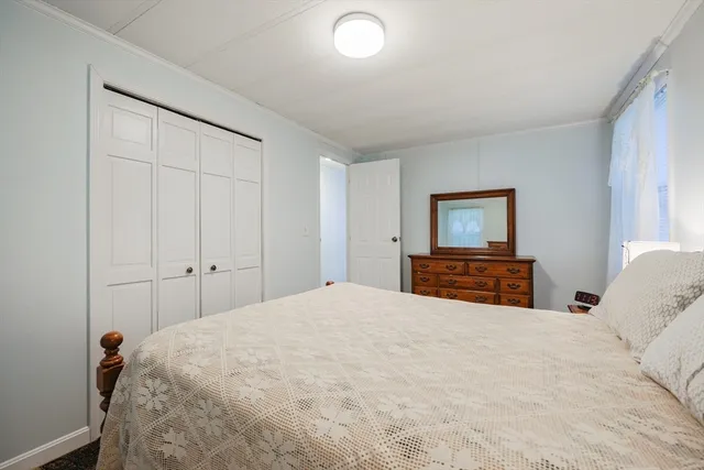 a bedroom with a large bed and a tv