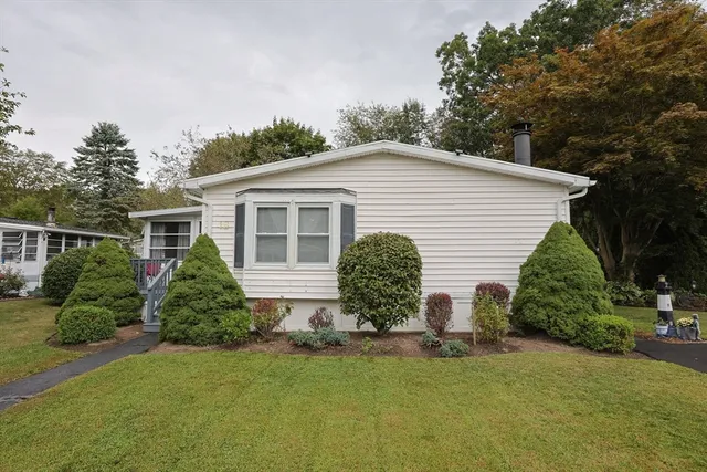 a view of a house with backyard and sitting area