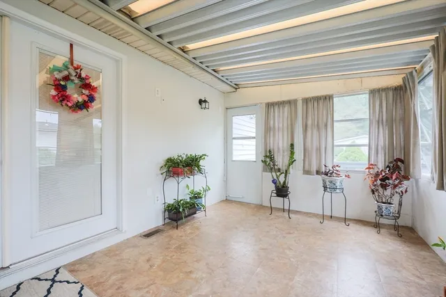 a living room with furniture and flowers