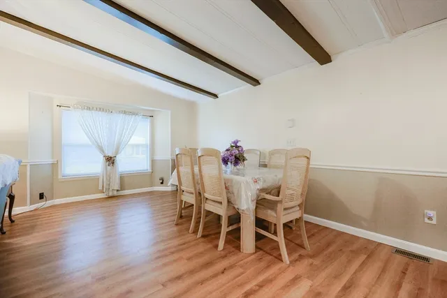a dining room with furniture and wooden floor